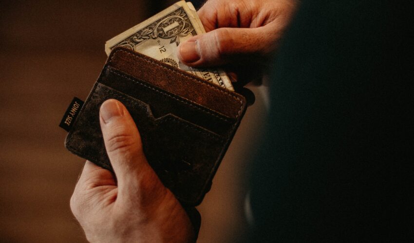 man pulling cash out of wallet