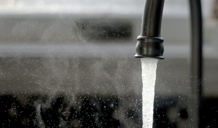 steam rising from hot water in a sink