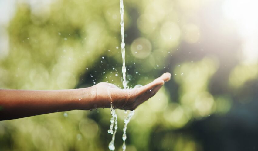 water pouring into child's hand